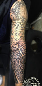 geometric tattoo on full arm or geometrical tattoo on full arm made by artist gupt ram