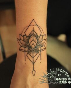 lotus geometric tattoo on wrist